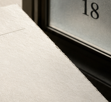 The number 18 seen through frosted glass beside Merovia materials